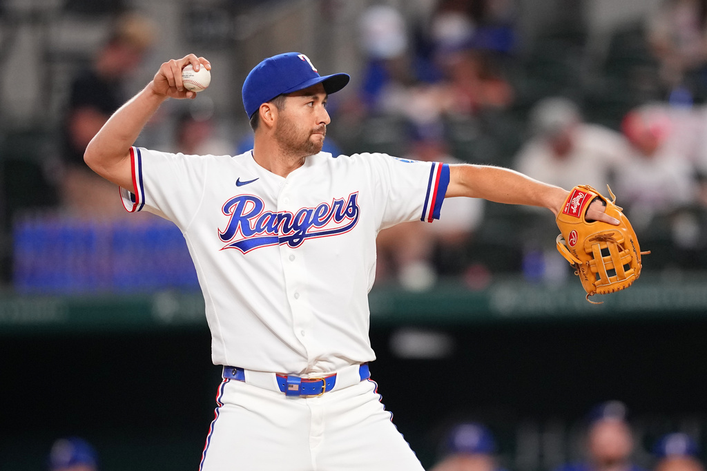Texas Rangers position player Kyle Higashioka pitches to the Los Angeles Angels during the ninth inning of a baseball game, Wednesday, July 8, 2026, in Arlington, Texas. (AP Photo/Julio Cortez)