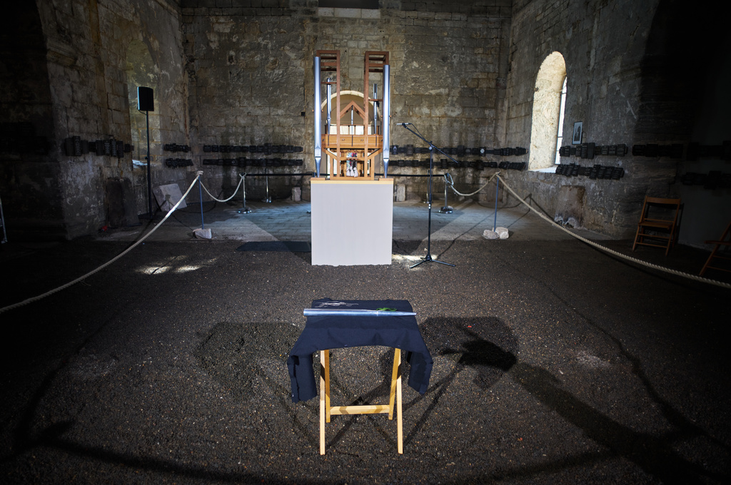 A new pipe for the John Cage Organ Project Halberstadt is placed in front of the organ prior to a chord change of the organ inside the medieval Burchardi Church in Halberstadt, Germany, Wednesday, Aug. 5, 2026. (AP Photo/Markus Schreiber)