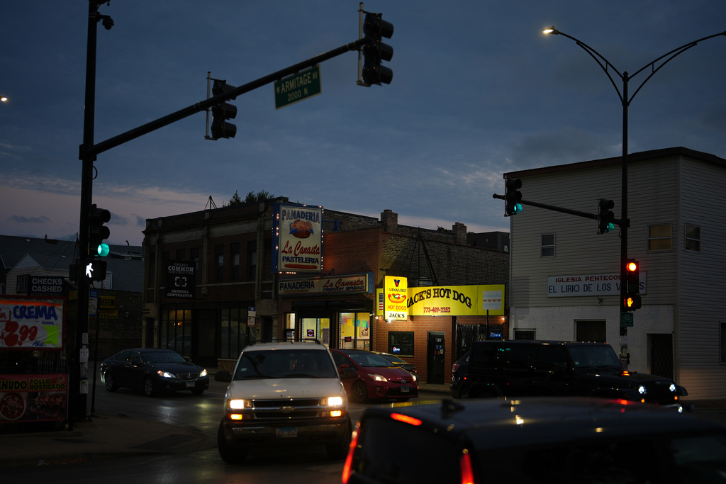 Drivers navigate past businesses outside Funston Elementary School in Chicago's Logan Square neighborhood, Tuesday, Oct. 14, 2025. (AP Photo/Rebecca Blackwell)