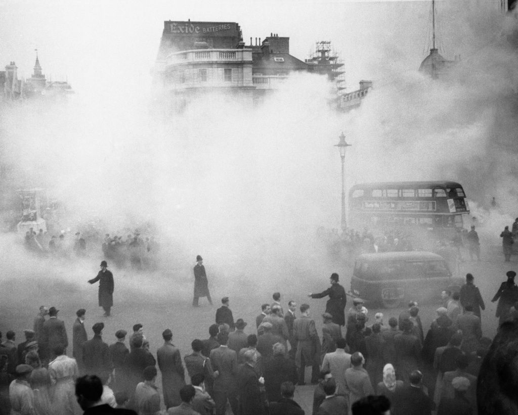 FILE - Smoke from fireworks falls on Trafalgar Square in London during a Labor Party rally in protest of the British government's handling of the Suez Canal crisis, Nov. 4, 1956. (AP Photo, File)