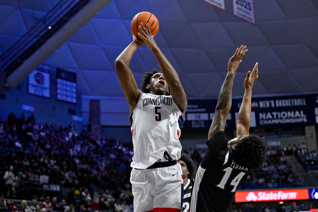 UConn forward Tarris Reed Jr. (5) shoots over Providence guard Corey Floyd (14) in the first half of an NCAA college basketball game, Tuesday, Jan. 27, 2026, in Storrs, Conn. (AP Photo/Jessica Hill)