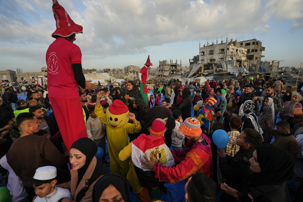 Palestinians celebrate Eid al-Fitr amid the rubble of destroyed buildings in Jabaliya, Gaza Strip, Friday, March 20, 2026. (AP Photo/Jehad Alshrafi)