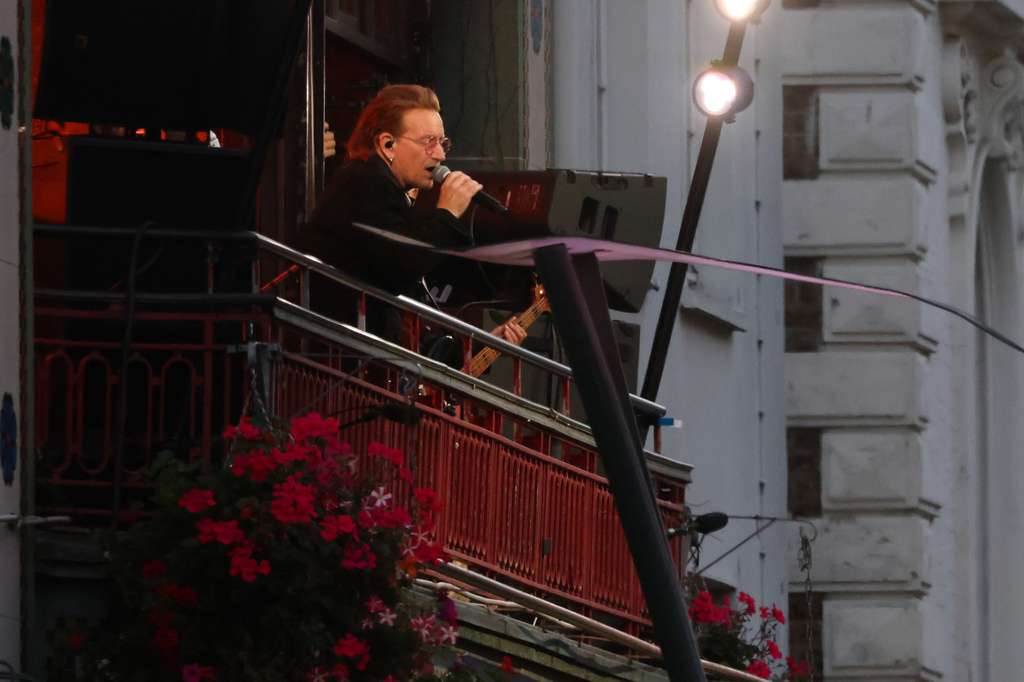 U2 perform an impromptu concert from a balcony in central Dublin, Ireland , Friday, Sept. 25, 2026. (AP Photo/Peter Morrison)