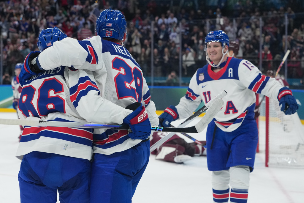 United States' Brock Nelson, center, celebrates with teammates after scoring his sides fourth goal during a preliminary round match of men's ice hockey between Latvia and the United States at the 2026 Winter Olympics, in Milan, Italy, Thursday, Feb. 12, 2026. (AP Photo/Carolyn Kaster)