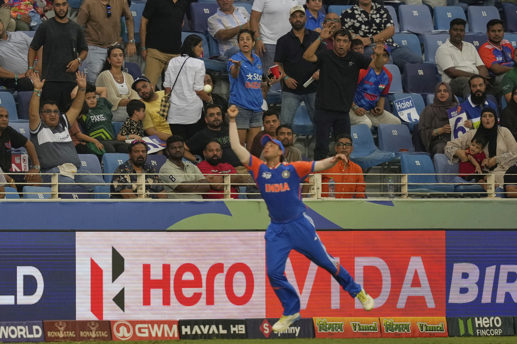 Spectators react as India's Abhishek Sharma drops the catch of Pakistan's Sahibzada Farhan during the Asia Cup cricket match between India and Pakistan at Dubai International Cricket Stadium in Dubai, United Arab Emirates, Sunday, Sept. 21, 2025. (AP Photo/Altaf Qadri)