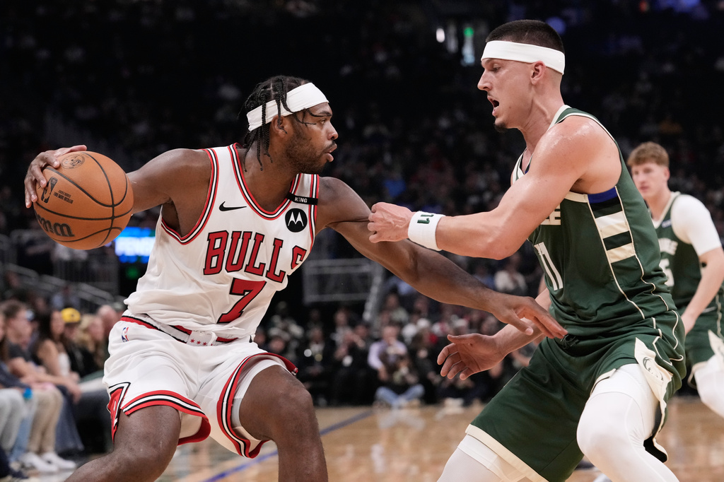 Chicago Bulls guard Buddy Hield, left, drives against Milwaukee Bucks guard Tyler Herro, right, during the first half of an NBA basketball game Friday, Oct. 23, 2026, in Milwaukee. (AP Photo/Nam Y. Huh)