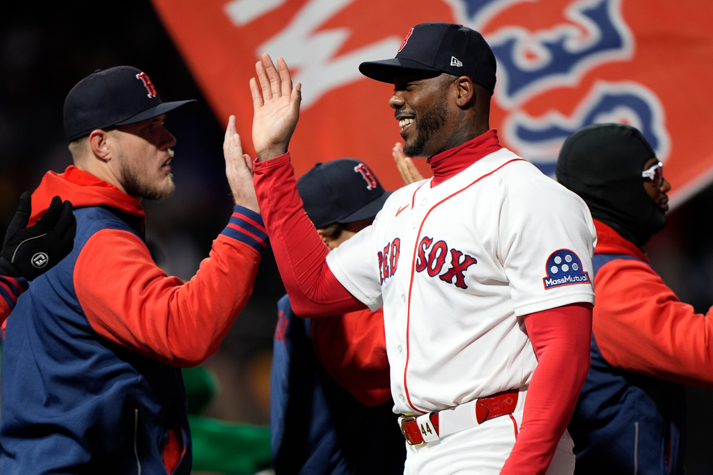Boston Red Sox pitcher Aroldis Chapman is congratulated after a victory against the Milwaukee Brewers in a baseball game Tuesday, April 7, 2026, in Boston. (AP Photo/Robert F. Bukaty)