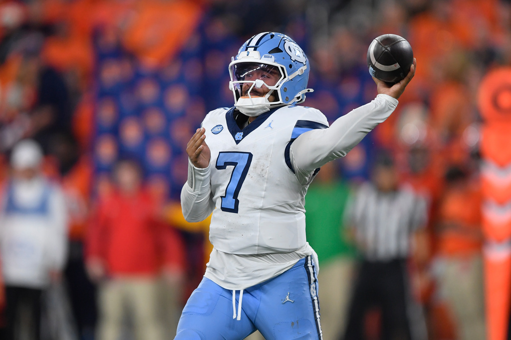 North Carolina quarterback Gio Lopez (7) throws during the first half of an NCAA football game against Syracuse, Friday, Oct. 31, 2025, in Syracuse, N.Y. (AP Photo/Adrian Kraus)
