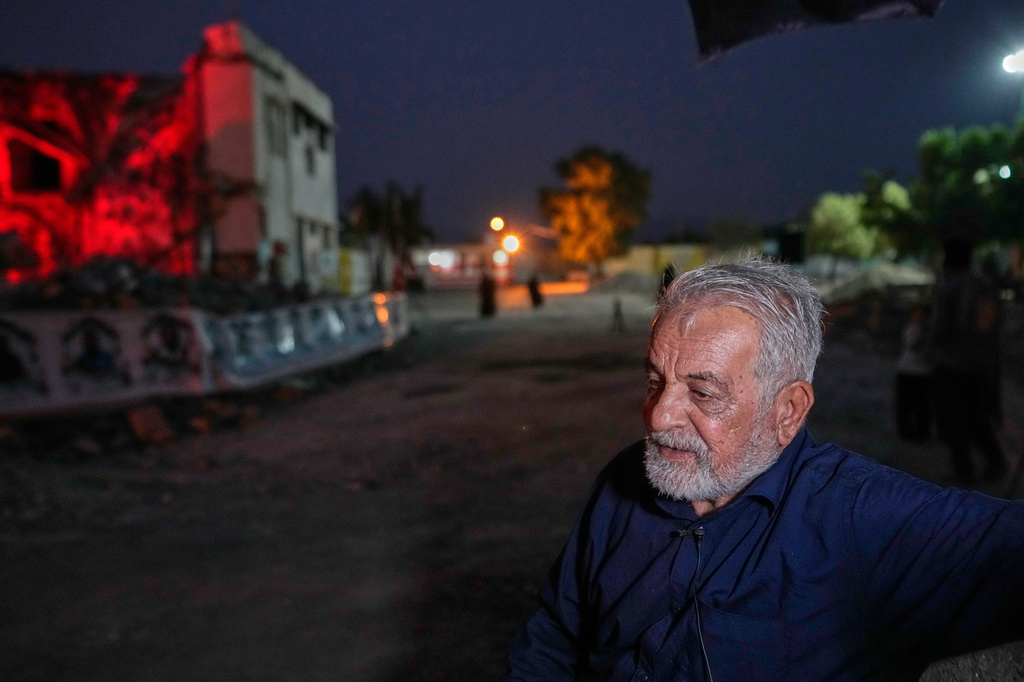 Heydar Sadeghi, whose 11-year-old grandson Hami and Hami's mother, Neda Salehizadeh, were killed here in a U.S. airstrike on Feb. 28, stands beside the shattered remains of Hami's school, Shajareh Tayyebeh, in Minab, southern Iran, Friday, Sept. 4, 2026. (AP Photo/Vahid Salemi)