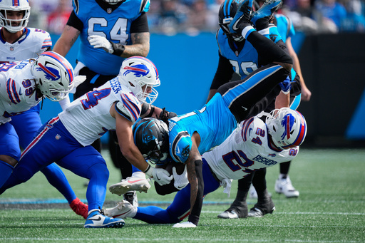 Buffalo Bills safety Cole Bishop (24) tackles Carolina Panthers running back Rico Dowdle (5) during the first half an NFL football game, Sunday, Oct. 26, 2025, in Charlotte, N.C. (AP Photo/Jacob Kupferman) Buffalo Bills safety Cole Bishop (24) tackles Carolina Panthers running back Rico Dowdle (5) during the first half an NFL football game, Sunday, Oct. 26, 2025, in Charlotte, N.C. (AP Photo/Jacob Kupferman)