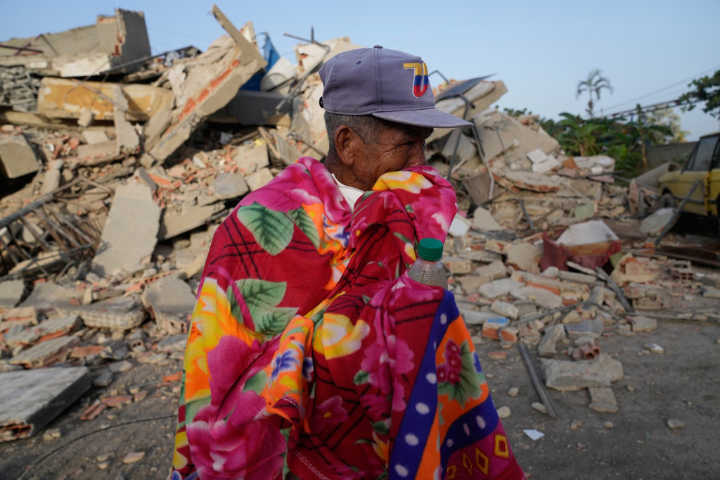 A man stands in front of a collapsed building two days after an earthquake struck La Guaira, Venezuela, Friday, June 26, 2026.(AP Photo/Ariana Cubillos)