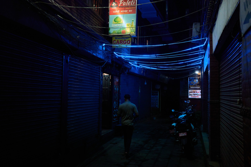 A man walks down an alley in a bustling neighborhood of Kathmandu, Nepal, Thursday, May 21, 2026. (AP Photo/Bram Janssen)