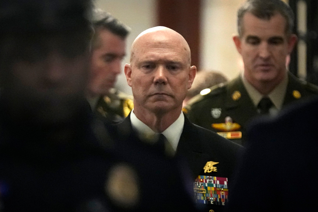 U.S. Navy Adm. Frank M. Bradley walks along a hallway after a meeting with senators on Capitol Hill, Thursday, Dec. 4, 2025, in Washington. (AP Photo/Mark Schiefelbein)