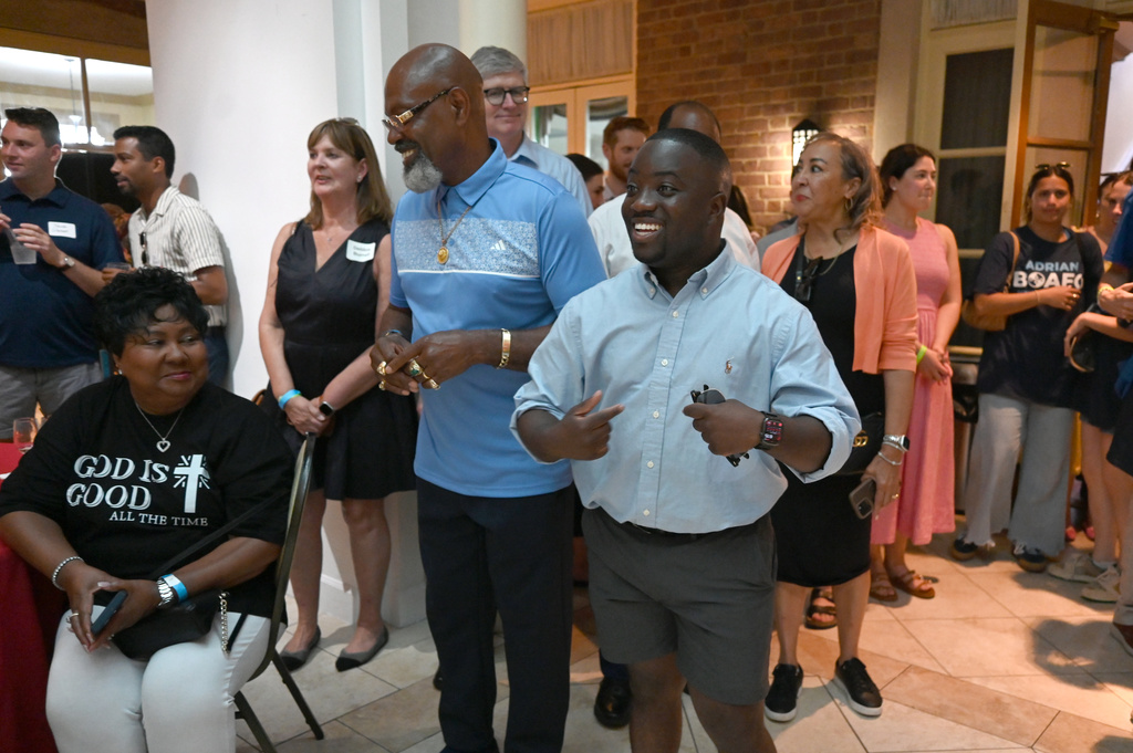 Adrian Boafo, right, a Maryland state delegate and candidate for U.S. Congress reacts after being acknowledged by U.S. Representative Steny Hoyer at the "AmeriPac Bull Roast" Friday, June 12, 2026, in Mitchellville, Md. (AP Photo/Gail Burton)