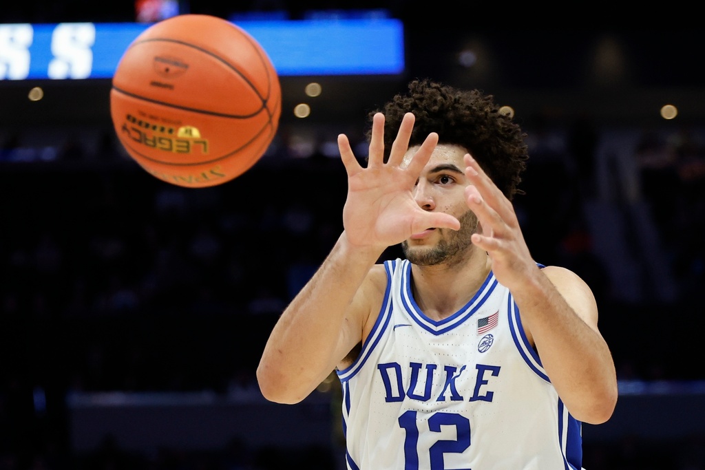 Duke forward Cameron Boozer catches a pass during the second half of an NCAA college basketball game against Virginia in the championship of the Atlantic Coast Conference tournament in Charlotte, N.C., Saturday, March 14, 2026. (AP Photo/Nell Redmond)