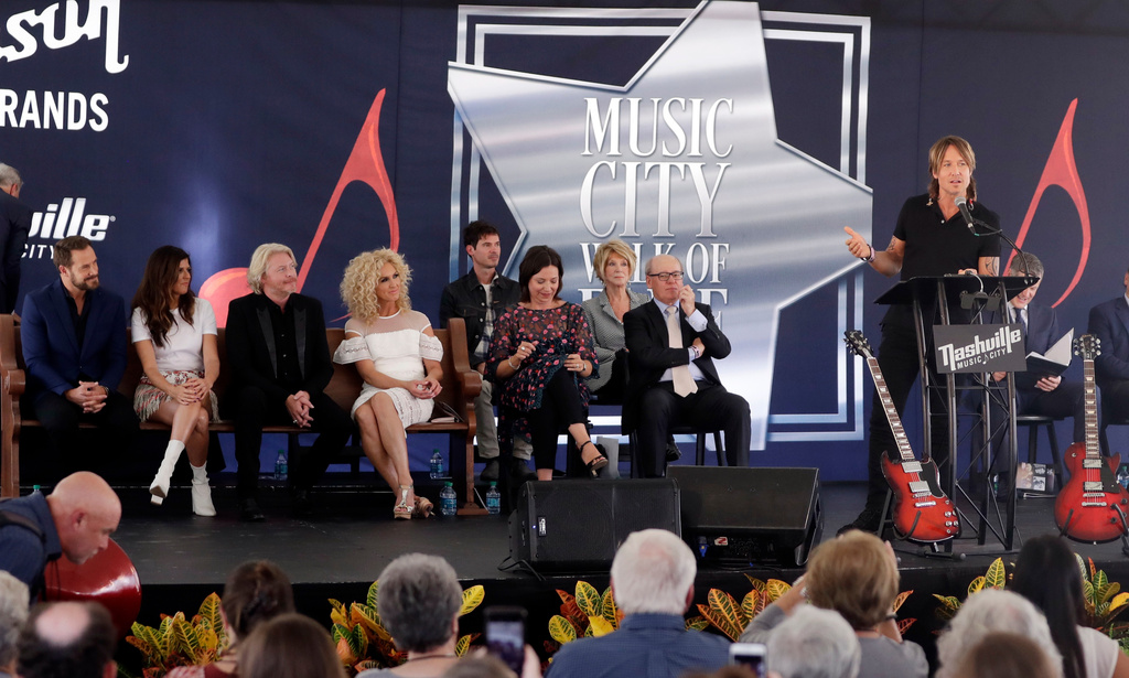 FILE - Keith Urban, right, introduces the band Little Big Town as they receive their star at the Music City Walk of Fame Sept. 14, 2017, in Nashville, Tenn. (AP Photo/Mark Humphrey, File)