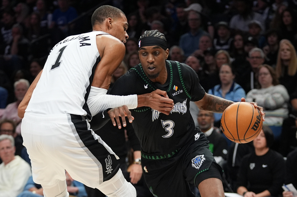 Minnesota Timberwolves forward Jaden McDaniels (3) drives against San Antonio Spurs forward Victor Wembanyama (1) during the first half of Game 3 of a NBA basketball second-round playoff series in Minneapolis, Friday, May 8, 2026. (AP Photo/Abbie Parr)
