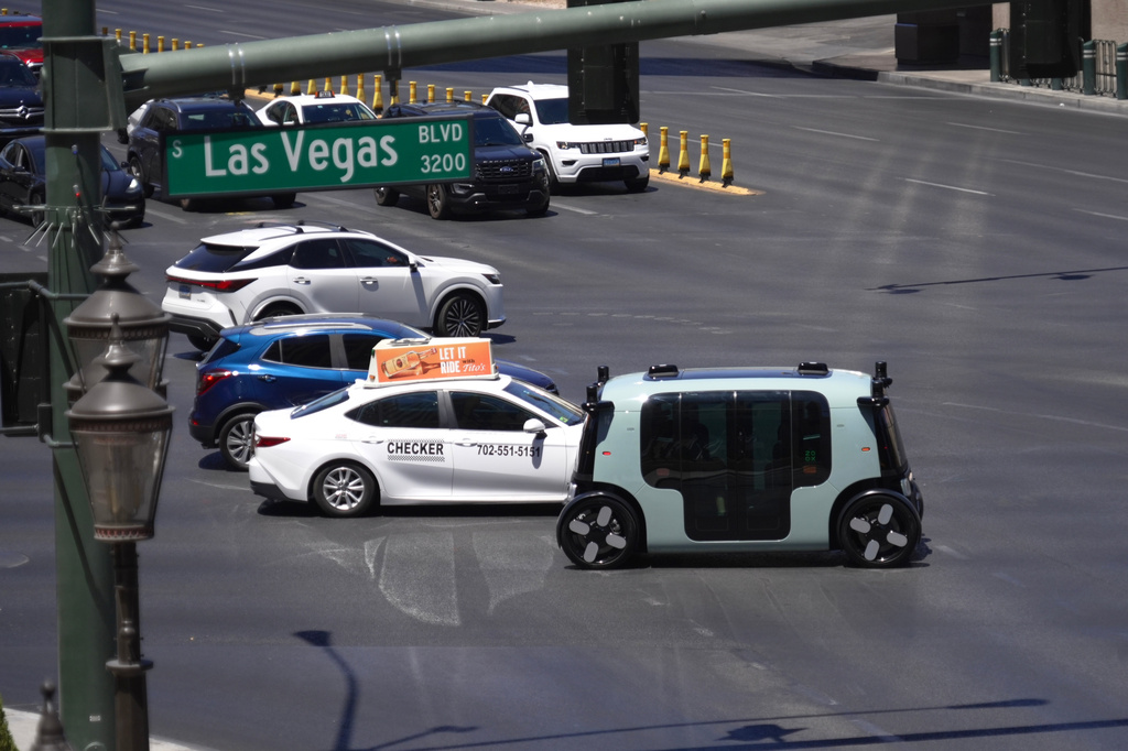 An Amazon Zoox taxi with no steering wheel drives down the Las Vegas strip, Thursday, July 30, 2026. (AP Photo/Ty ONeil)
