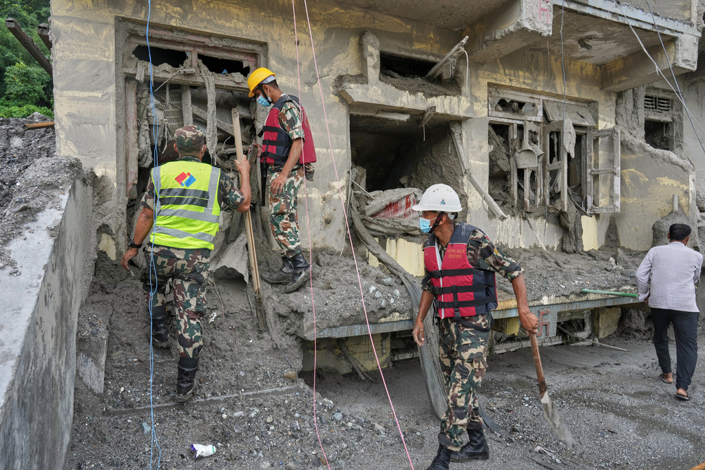 Rescuers inspect a residential building damaged in the aftermath of the flash floods in Nepal's Nuwakot district, Wednesday, Sept. 2, 2026. (AP Photo/Rajesh Kumar Singh)