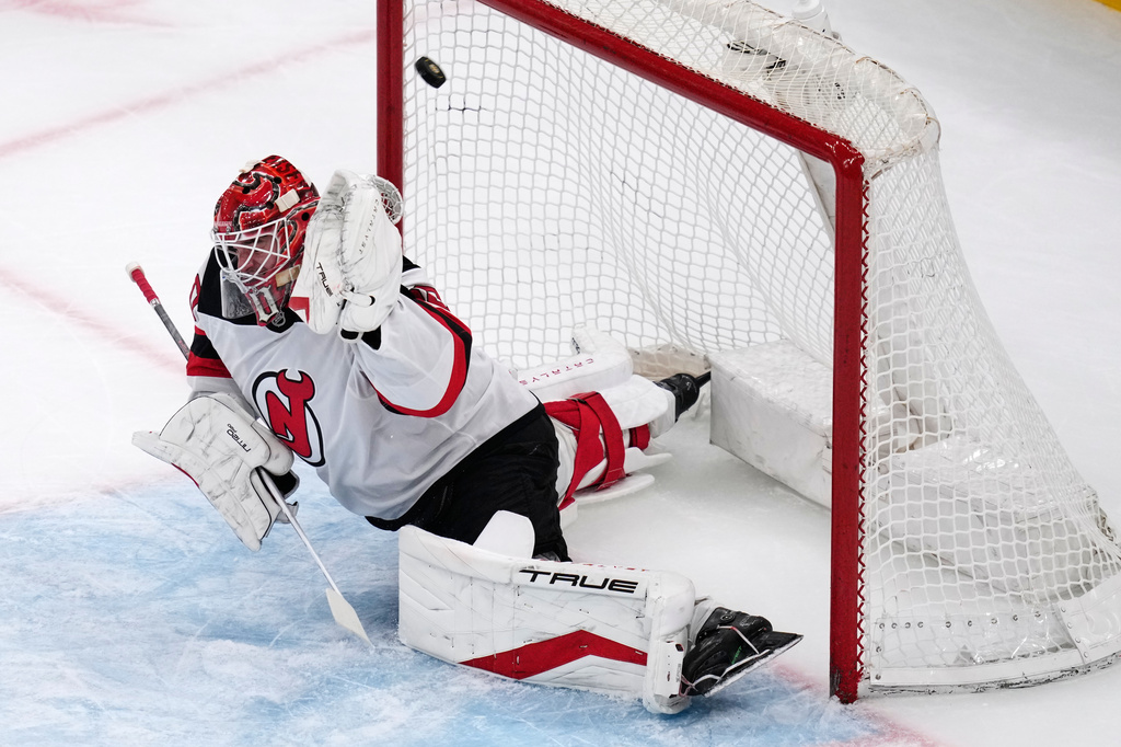 New Jersey Devils goaltender Nico Daws (50) fails to make a save on a shot by Boston Bruins center Mark Kastelic during the first period of a hockey game, Tuesday, April 14, 2026, in Boston. (AP Photo/Charles Krupa)
