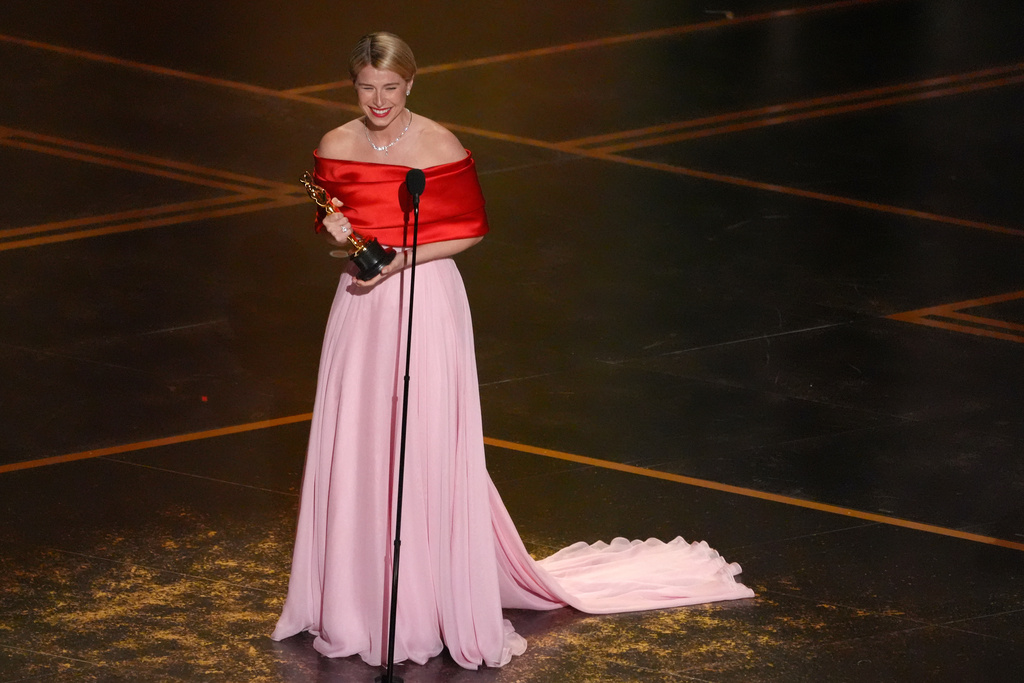 Jessie Buckley accepts the award for actress in a leading role for "Hamnet" during the Oscars on Sunday, March 15, 2026, at the Dolby Theatre in Los Angeles. (AP Photo/Chris Pizzello)