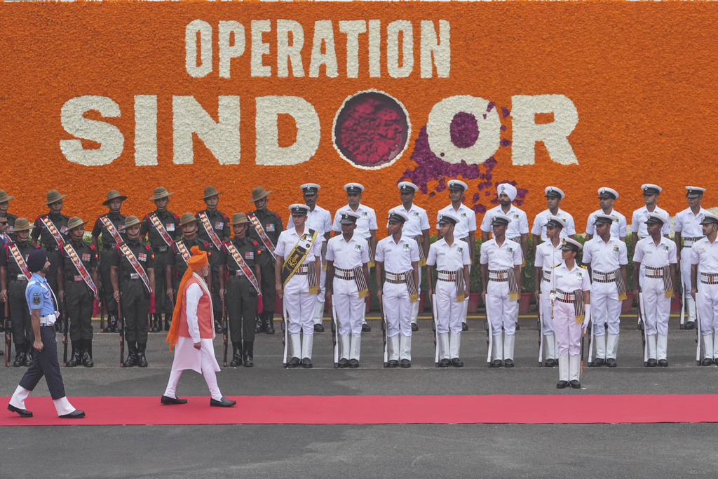 Indian Prime Minister Narendra Modi, in orange turban, inspects a joint military guard of honor as he arrives to address the nation from the rampart of the 17th century Mughal-era Red Fort monument during the country's Independence Day celebrations in New Delhi, India, Friday, Aug. 15, 2025. (AP Photo/Manish Swarup)