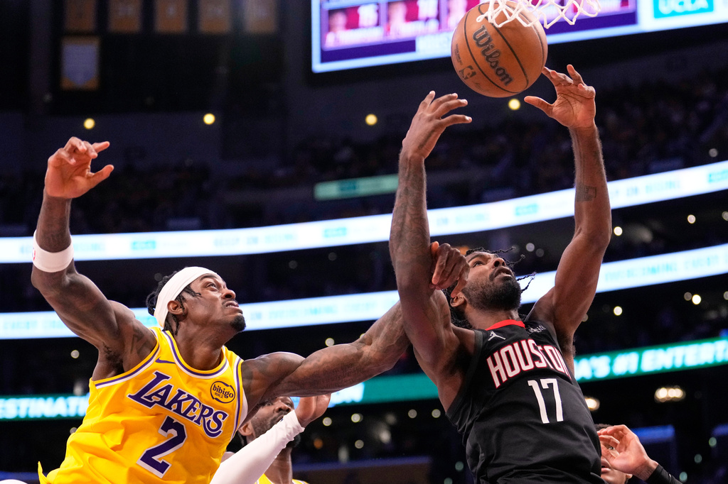 Los Angeles Lakers forward Jarred Vanderbilt, left, and Houston Rockets forward Tari Eason go after a rebound during the second half in Game 1 of a first-round NBA playoffs basketball series Saturday, April 18, 2026, in Los Angeles. (AP Photo/Mark J. Terrill)