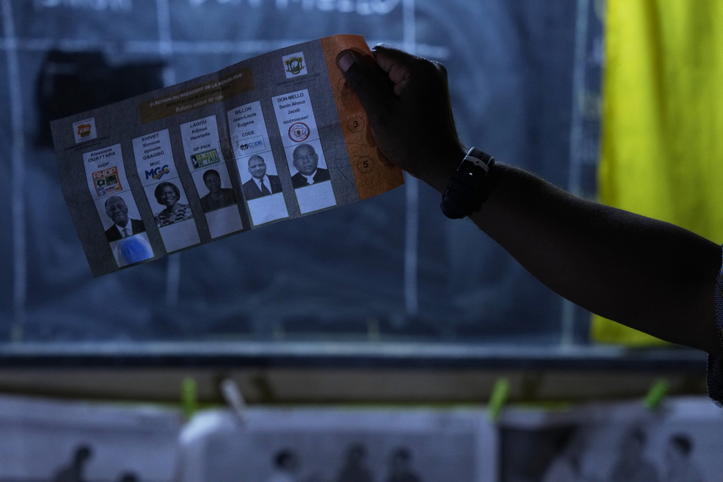 Officials count votes at a polling station in the Yopougon suburb of Abidjan, Ivory Coast, Saturday, Oct. 25, 2025, as polls close during the presidential elections. (AP Photo/Misper Apawu)