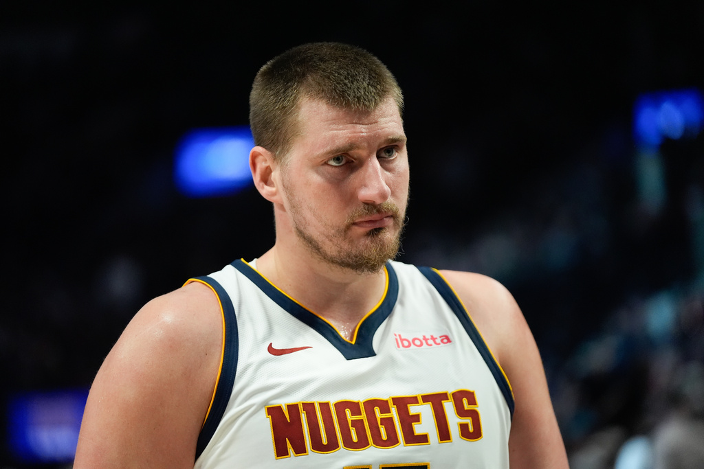 Denver Nuggets center Nikola Jokić looks on during the first half of an NBA basketball game against the Portland Trail Blazers, Friday, Feb. 20, 2026, in Portland, Ore. (AP Photo/Jenny Kane)