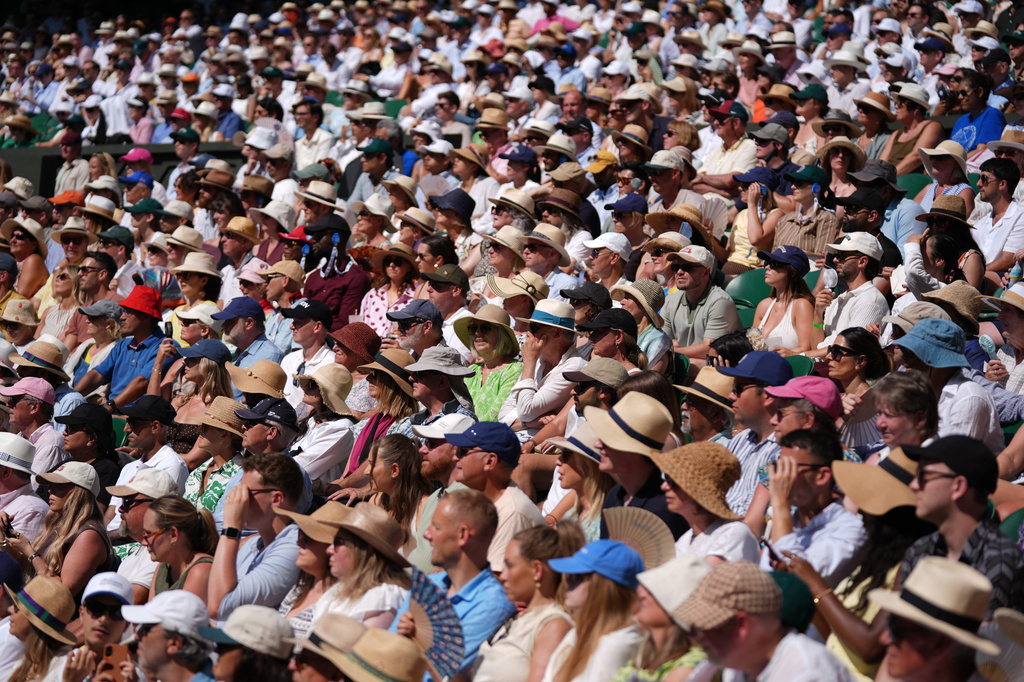 Spectators wearing hats to shelter from the sun watch the quarter-final men's singles match between Arthur Fery of Britain and Flavio Cobolli of Italy, on day ten of the Wimbledon Tennis Championships in London, Wednesday, July 8, 2026. (AP Photo/Maja Smiejkowska)