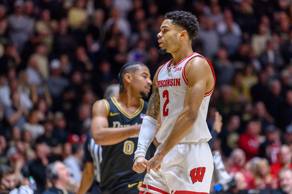 Wisconsin's Nick Boyd celebrates as Purdue's C.J. Cox looks on during an NCAA college basketball game Saturday, March 7, 2026, in West Lafayette, Ind. (AP Photo/Craig Pessman)