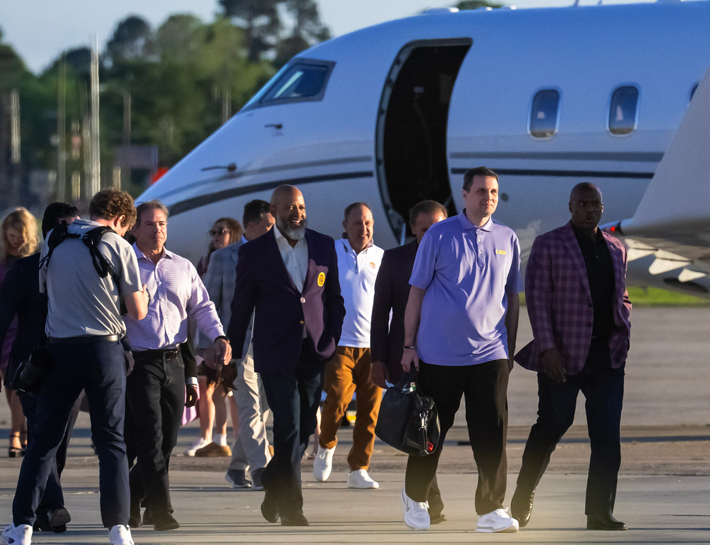 FILE - Newly-hired LSU men's basketball coach Will Wade, second from right, walks with LSU athletic director Verge Ausberry, right, and others after landing, Thursday, March 26, 2026, in Baton Rouge, La. (Michael Johnson/The Advocate via AP, File)