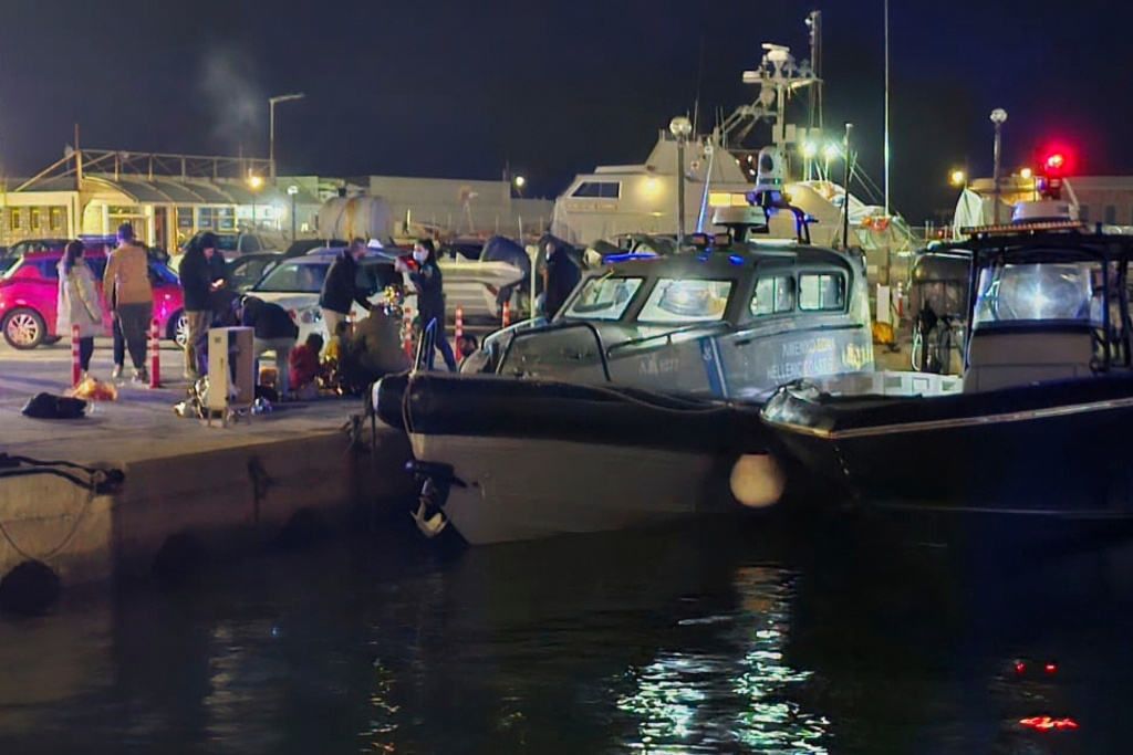 Greek coast guard officers carry out rescue operations at a port on the eastern Aegean island of Chios, Greece, late Tuesday, Feb. 3, 2026, after a collision between a migrant speedboat and a coast guard patrol vessel killed multiple people, authorities said. (Pantelis Fykaris/Politischios.gr via AP)