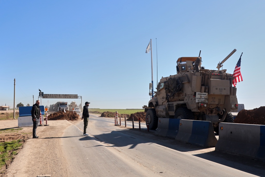 A convoy carrying U.S. Army vehicles drives away from the International Coalition's Qasrak Base, its largest base in northeastern Syria, heading toward Iraqi territory on the outskirts of Qamishli, eastern Syria, Monday, Feb. 23, 2026.(AP Photo/Baderkhan Ahmad)