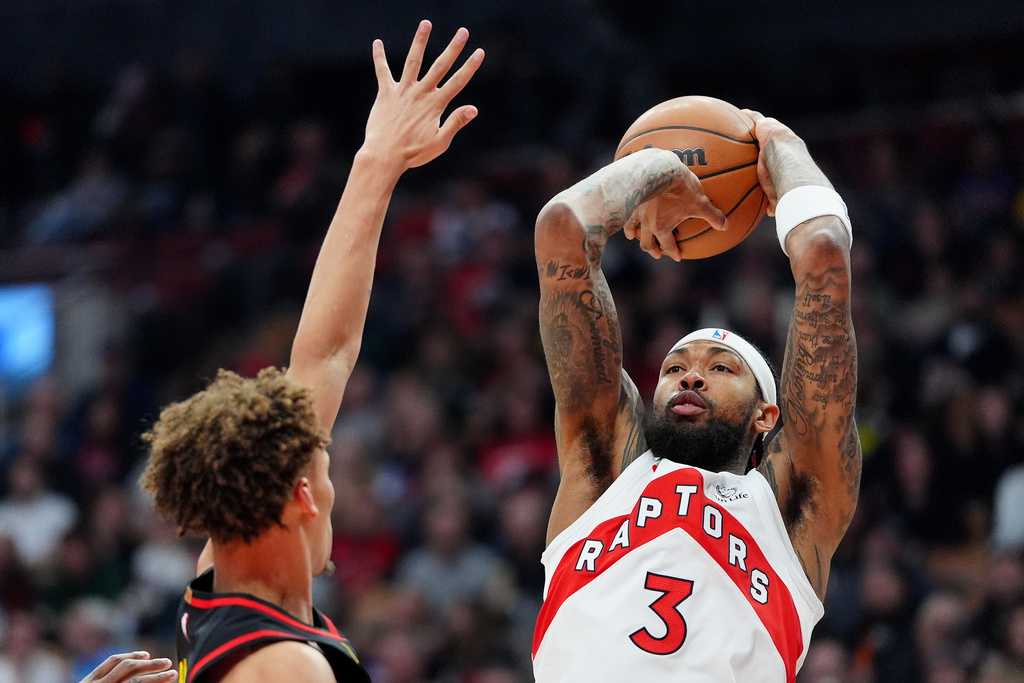 Atlanta Hawks guard Dyson Daniels, left, tries to stop Toronto Raptors forward Brandon Ingram (3) who looks to shoot during first-half NBA basketball game action in Toronto, Monday, Jan. 5, 2026. (Frank Gunn/The Canadian Press via AP)