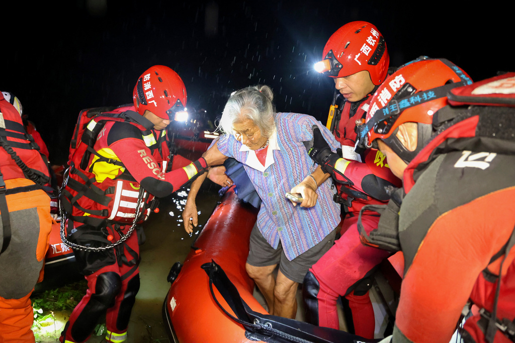 In this photo released by Xinhua News Agency, rescuers evacuate a stranded resident after tropical storm Maysak past Liujia Village in Qinzhou, south China's Guangxi Zhuang Autonomous Region, July 7, 2026. (Ao Shuaichang/Xinhua via AP)