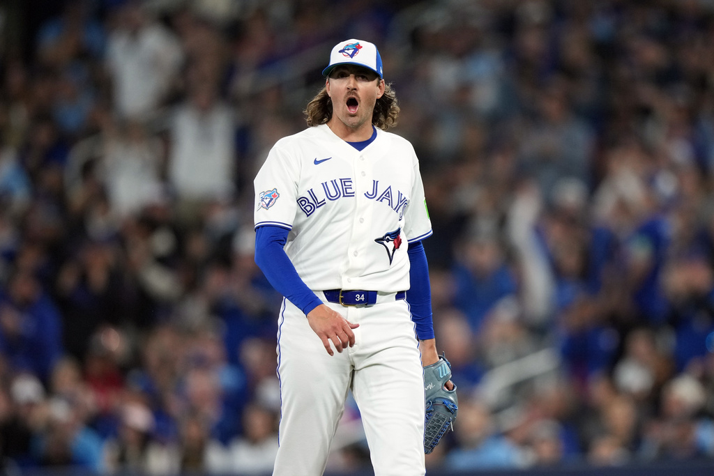 Toronto Blue Jays pitcher Kevin Gausman reacts after throwing a strikeout against the Athletics during first-inning baseball game action in Toronto, Friday, March 27, 2026. (Nathan Denette/The Canadian Press via AP)