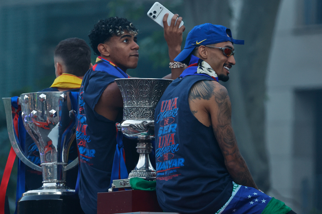 FC Barcelona players Lamine Yamal, left, and Raphinha celebrate atop a bus after winning the Spanish La Liga title in Barcelona, Spain, Monday, May 11, 2026. (AP Photo/Joan Monfort)