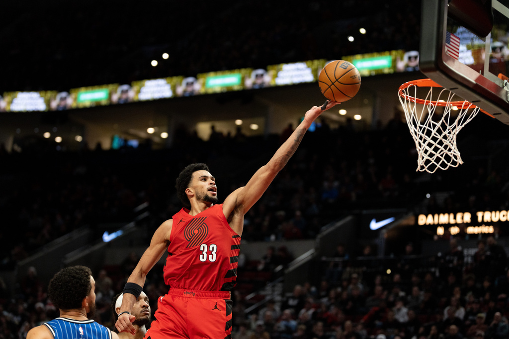 Portland Trail Blazers forward Toumani Camara drives to the basket against the Orlando Magic during the second half of an NBA basketball game Tuesday Dec. 23, 2025, in Portland, Ore. (AP Photo/Howard Lao)