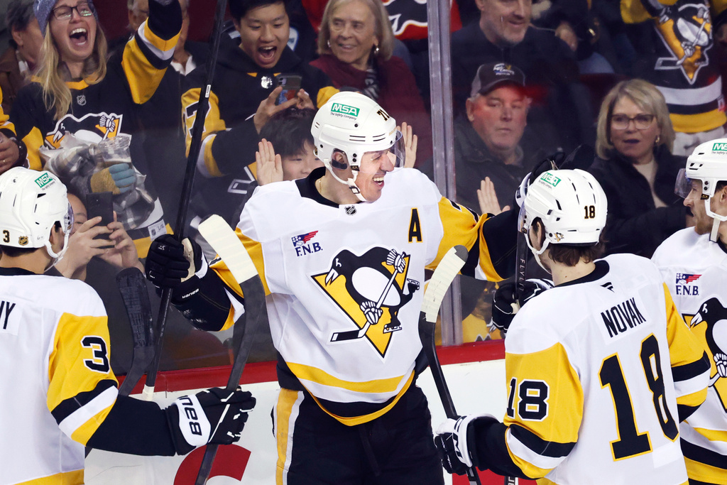 Pittsburgh Penguins' Evgeni Malkin centre, celebrates his goal against the Calgary Flames with teammates during the first period of an NHL hockey game in Calgary, Wednesday, Jan. 21, 2026. (Larry MacDougal/The Canadian Press via AP)