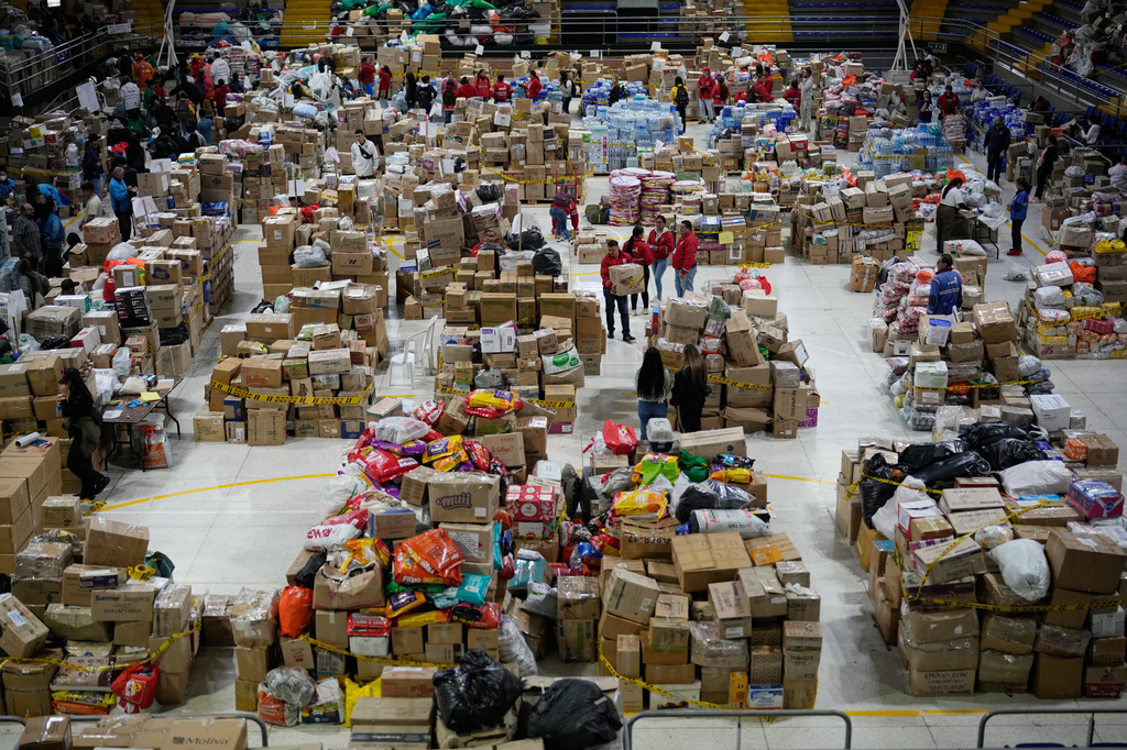 Volunteers sort aid bound for people affected by the earthquake in Choco department, in Bogota, Colombia, Tuesday, Aug. 18, 2026. (AP Photo/Fernando Vergara)