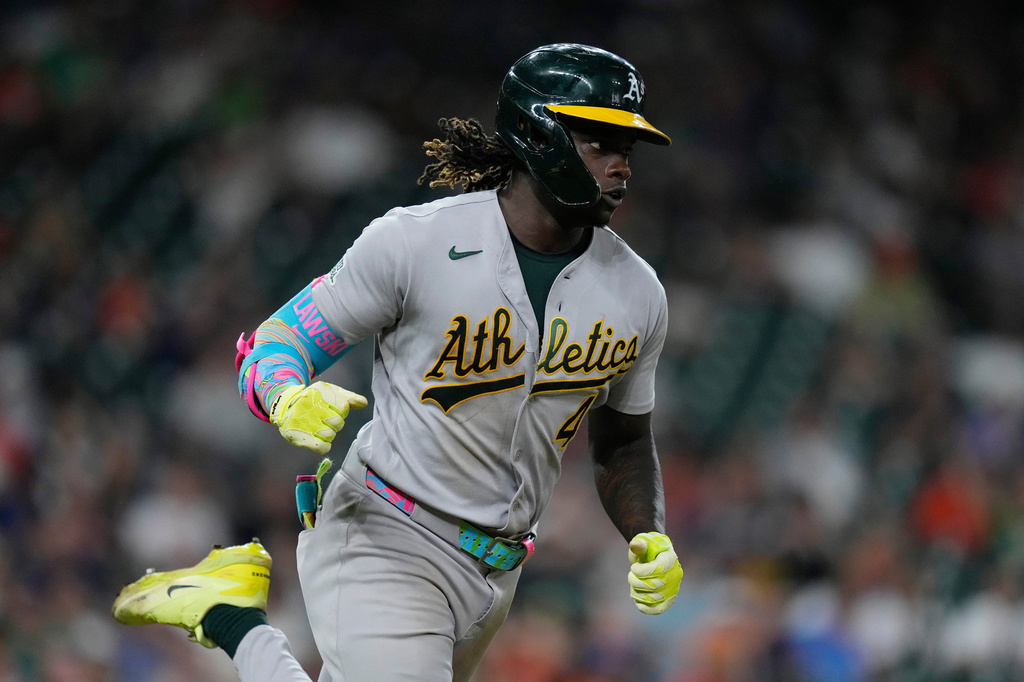 Athletics' Lawrence Butler runs to first base after hitting an RBI single during the eighth inning of a baseball game against the Houston Astros, Saturday, Aug. 22, 2026, in Houston. (AP Photo/Kevin M. Cox)
