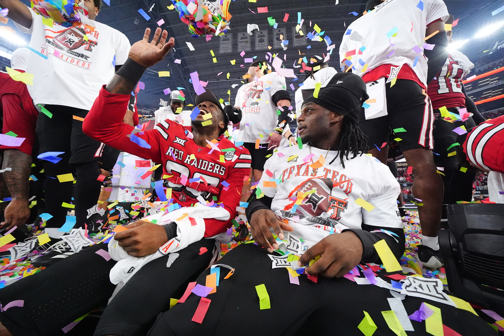 Texas Tech players celebrate their team's win against BYU in the Big 12 Conference championship NCAA college football game Saturday, Dec. 6, 2025, in Arlington, Texas. (AP Photo/Julio Cortez)