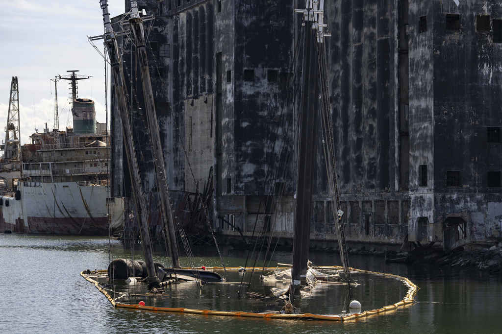 Debris of the Victory Chimes and the Pilot floats in the Henry Street Basin, Wednesday, Aug. 26, 2026, in the Brooklyn borough of New York. (AP Photo/Yuki Iwamura)