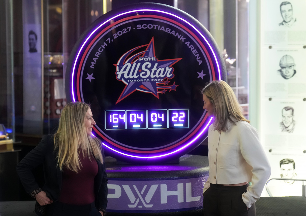 Jayna Hefford, left, Executive Vice President of Hockey Operations for the PWHL, and Laura Stacey, PWHL Players Association President talk as they announce the first ever PWHL All-Star Game, which will take place in Toronto next year, during a press conference in Toronto, Thursday, Sept. 24, 2026. (Nathan Denette/The Canadian Press via AP)