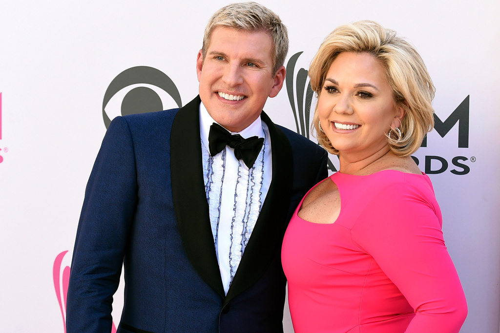 FILE - Julie Chrisley, right, and her husband Todd Chrisley pose for photos at the 52nd annual Academy of Country Music Awards in Las Vegas April 2, 2017. (Jordan Strauss/Invision/AP, File)