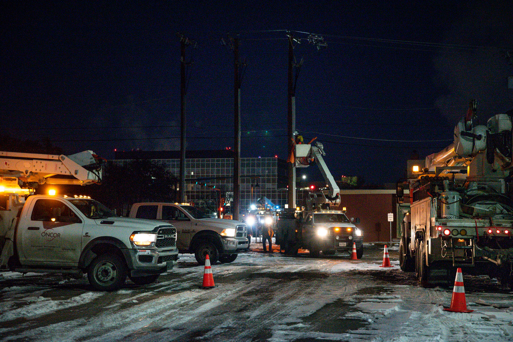 FILE - An Oncor Electric Delivery lineman crew works on repairing a utility pole that was damaged by a winter storm on Feb. 18, 2021, in Odessa, Texas. (Eli Hartman/Odessa American via AP, File)