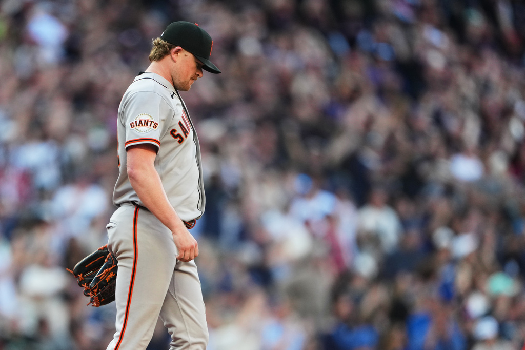 San Francisco Giants starting pitcher Logan Webb reacts to giving up a three-run home run to Seattle Mariners' Cole Young during the seventh inning of a baseball game, Saturday, July 18, 2026, in Seattle. (AP Photo/Lindsey Wasson)