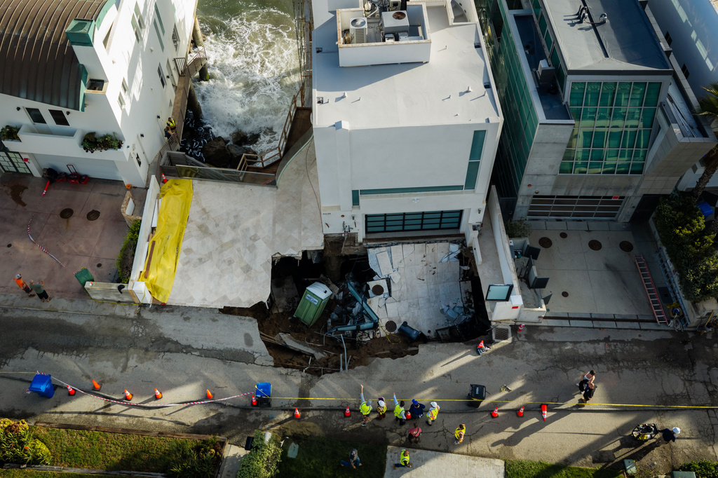 An aerial view of a sinkhole which collapsed the driveway of a coastal mansion owned by actor Nicolas Cage Tuesday, Sept. 8, 2026, in Malibu, Calif. (AP Photo/Ethan Swope)