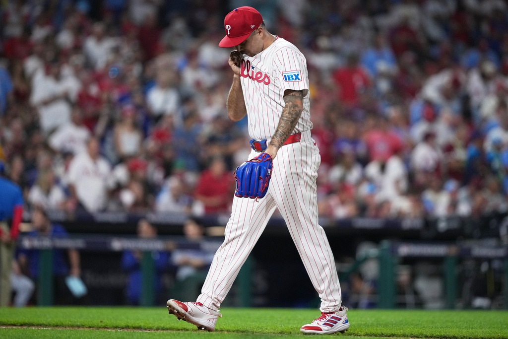 Philadelphia Phillies relief pitcher Orion Kerkering reacts while walking back to the dugout after being relieved during the seventh inning in Game 2 of baseball's National League Division Series against the Los Angeles Dodgers, Monday, Oct. 6, 2025, in Philadelphia. (AP Photo/Matt Slocum)